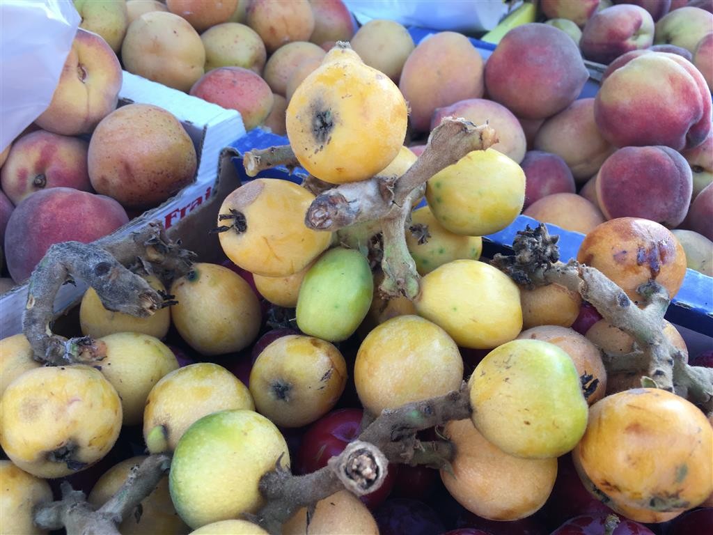 A pile of fresh loquat fruits at a vendors stall 